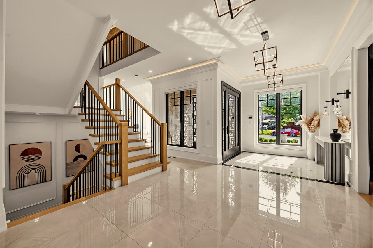 Foyer with the open oak and iron staircase, sightline running the depth of the house