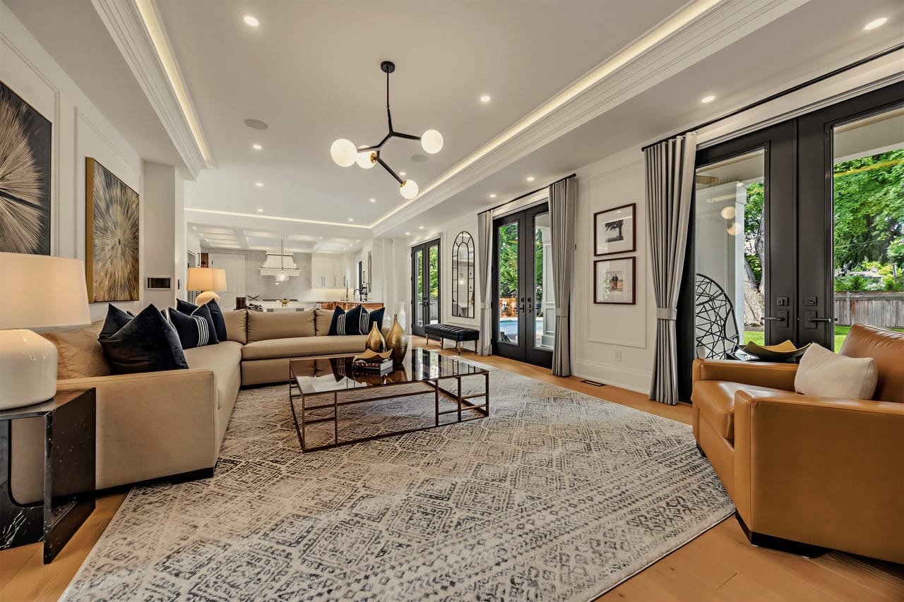 Living room looking toward the garden doors, layered seating on a hand-knotted rug
