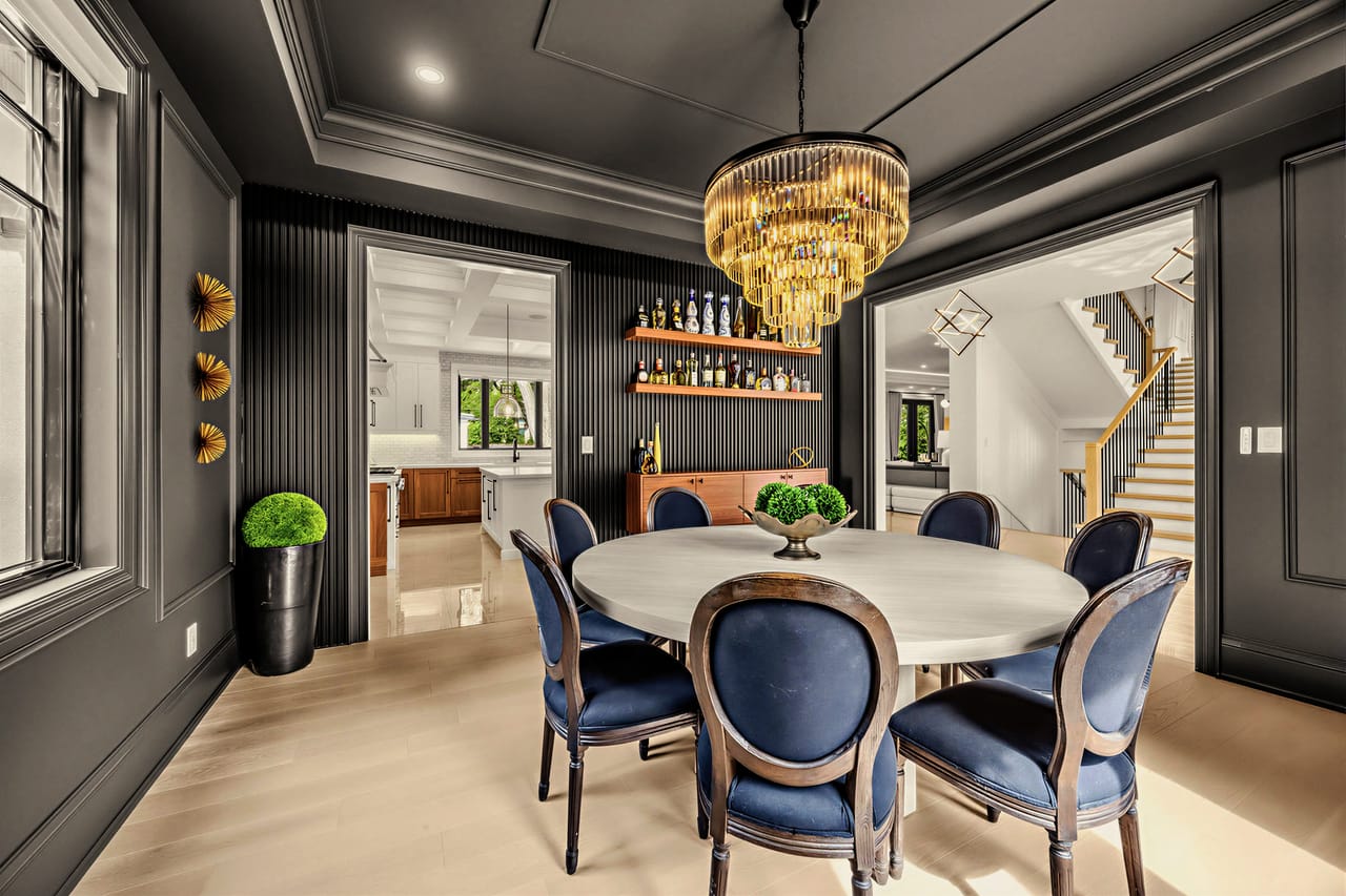 Dining room with fluted millwork and open bar shelving, sightline through to the stair