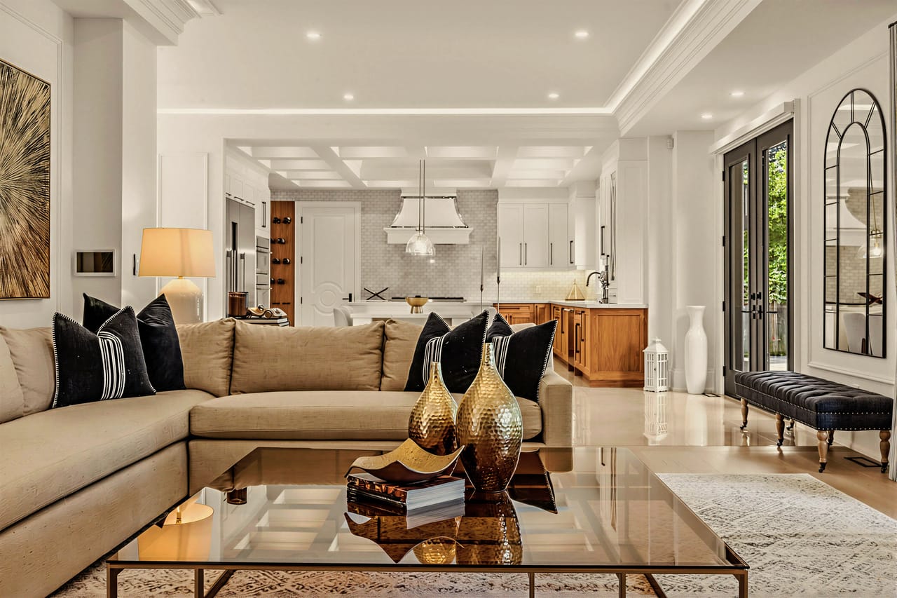 Family room sectional facing the kitchen, arched mirror and garden doors to the right