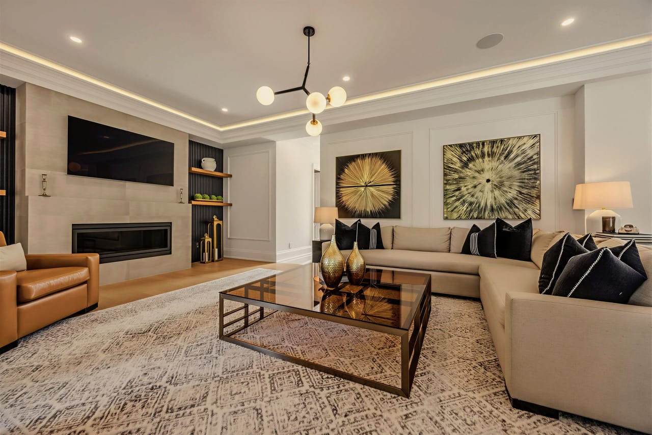 Wide view of the family room, leather and linen seating around the fireplace
