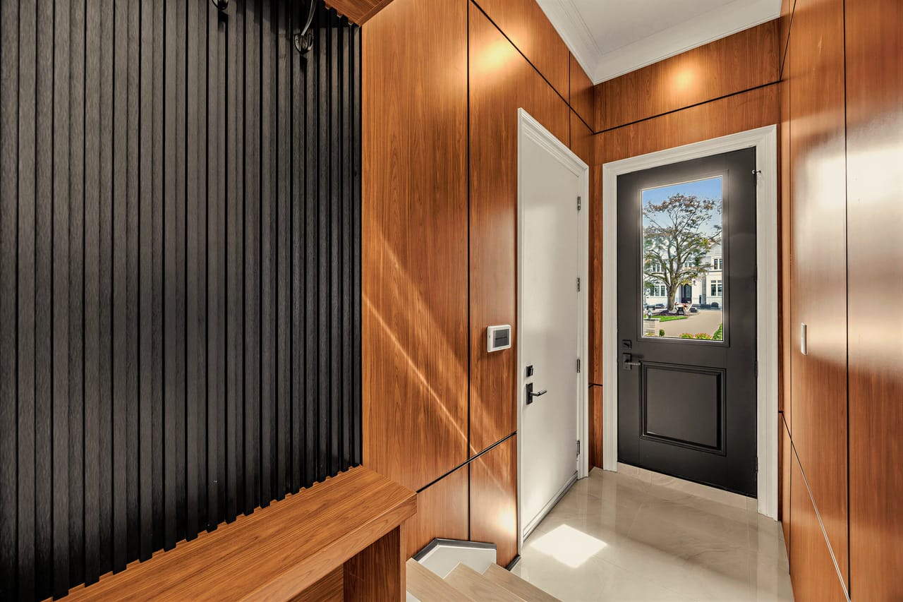 Rear hall in slatted charcoal and warm oak, leading to the side entrance