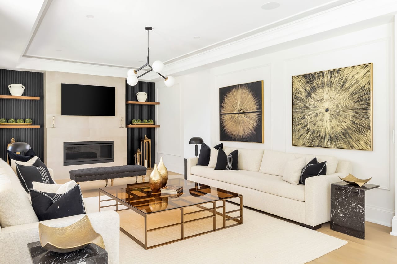 Family room fireplace and media wall, flanked by fluted niches and walnut shelves