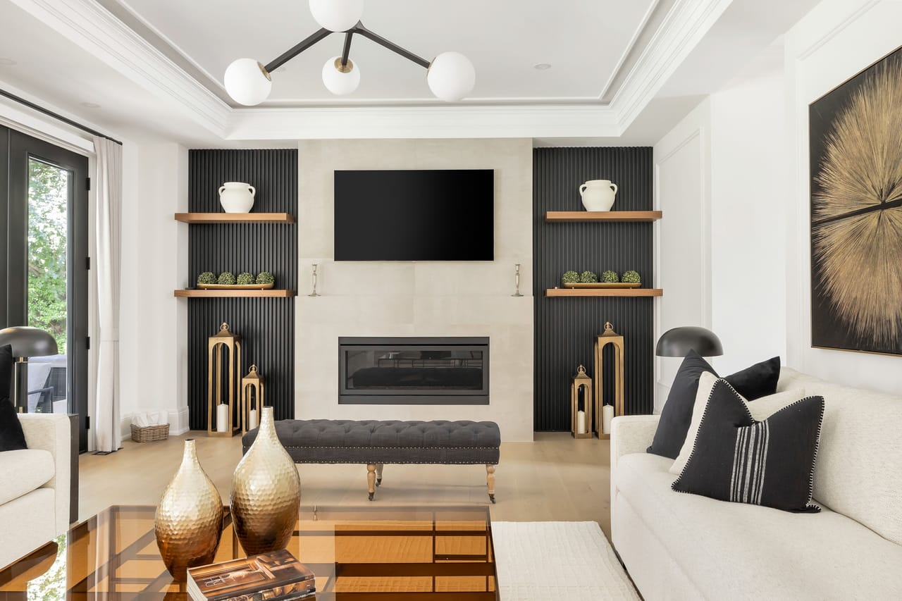 Family room seating beneath a globe fixture, with garden doors and fluted accent walls
