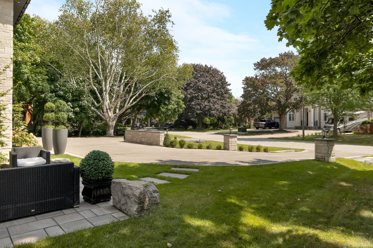 Side garden in daylight, a flagstone path leading toward the driveway