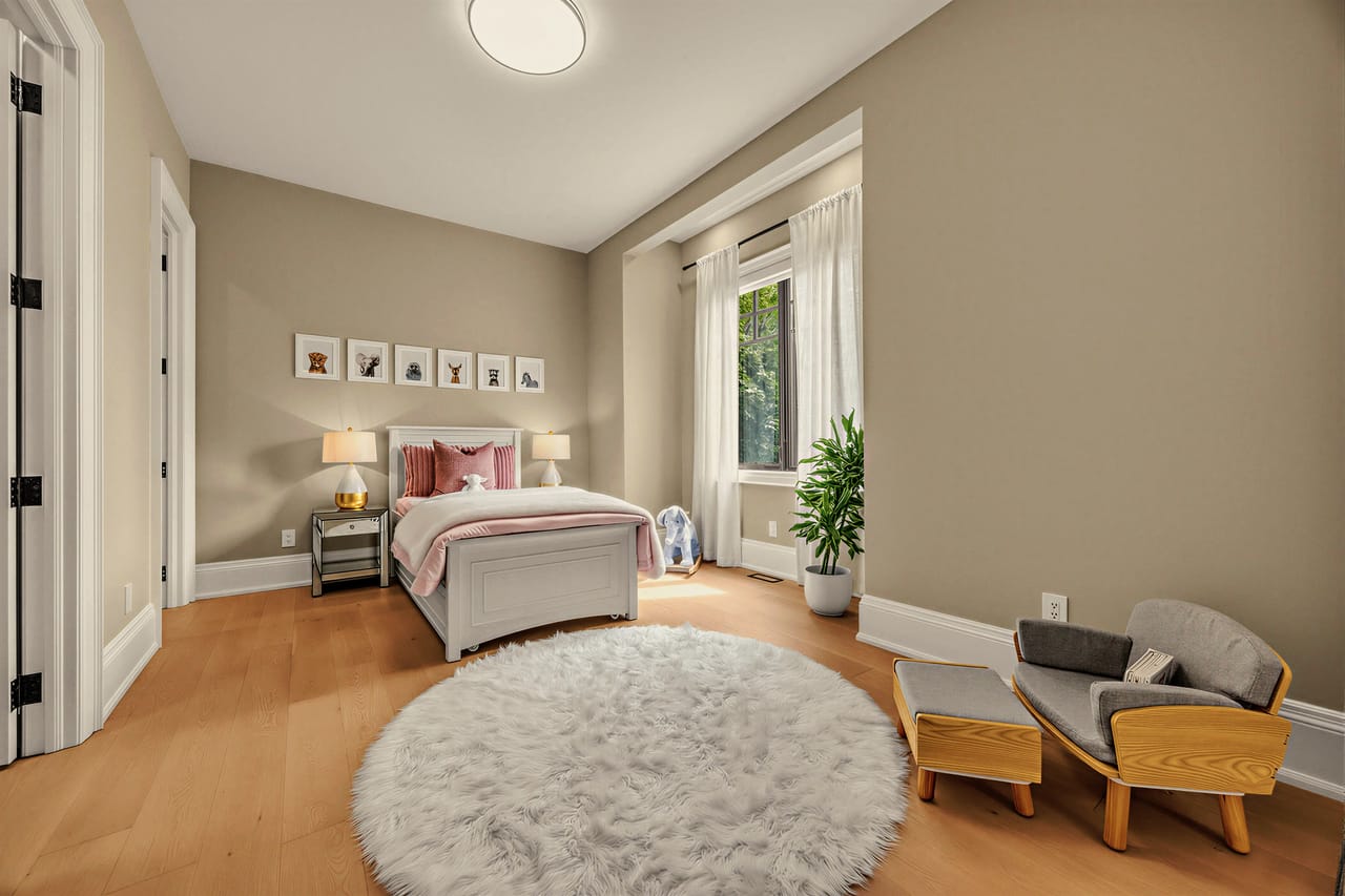 Corner bedroom under a vaulted ceiling, window bay to the garden