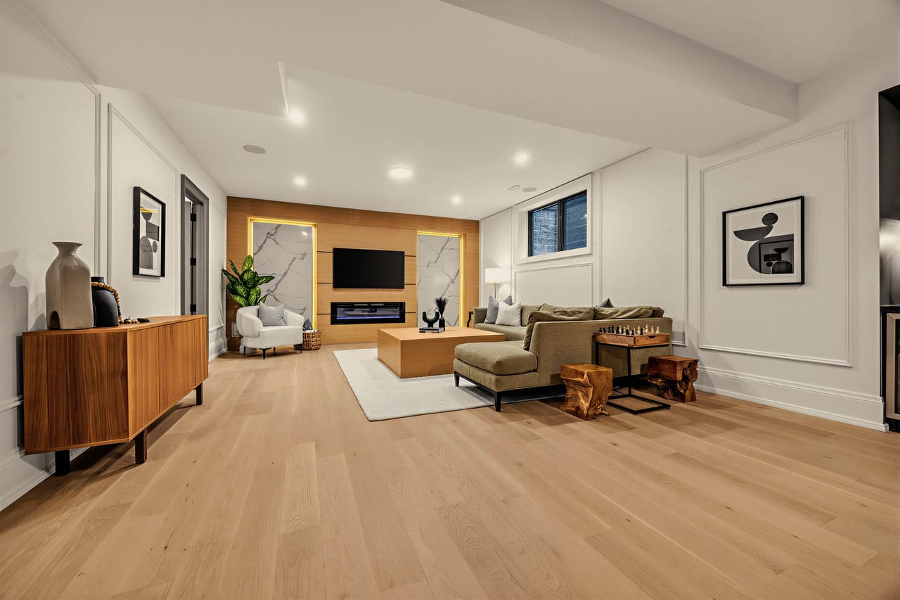 Lower level seating gathered around the rec room fireplace