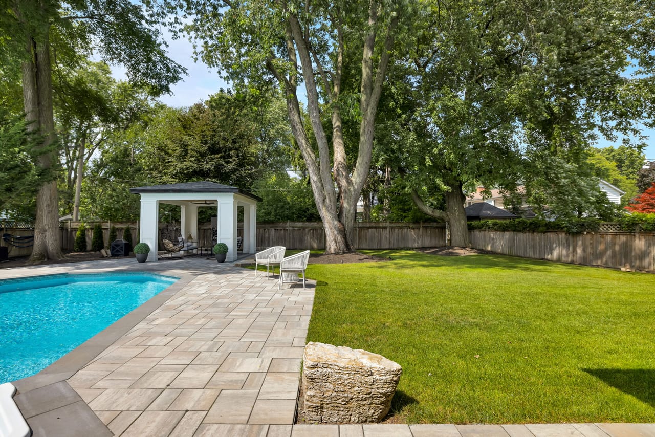 Expansive backyard with the pool, cabana, and a deep run of level lawn