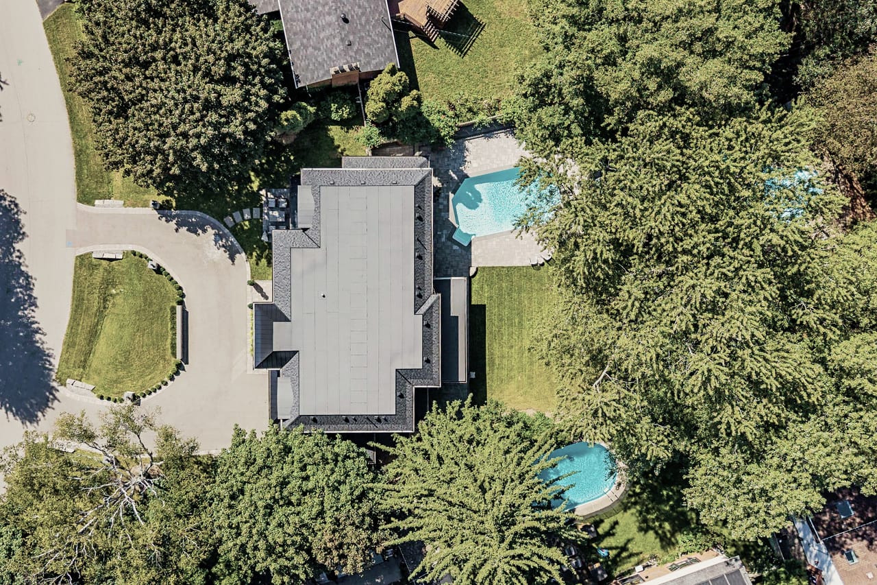 Overhead view of the property, the circular drive, roofline and pool on a 0.37 acre lot