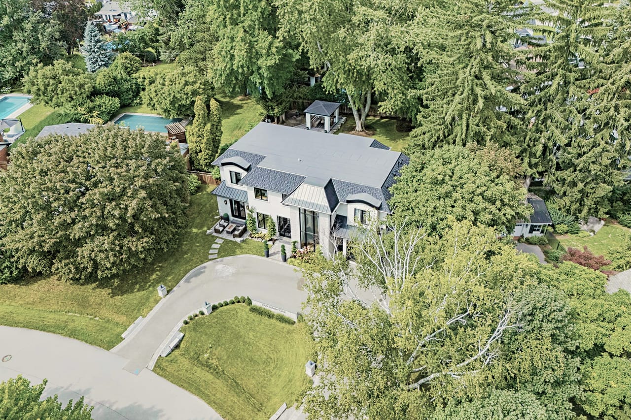 The property from the air, set back behind mature trees on Venetia Drive
