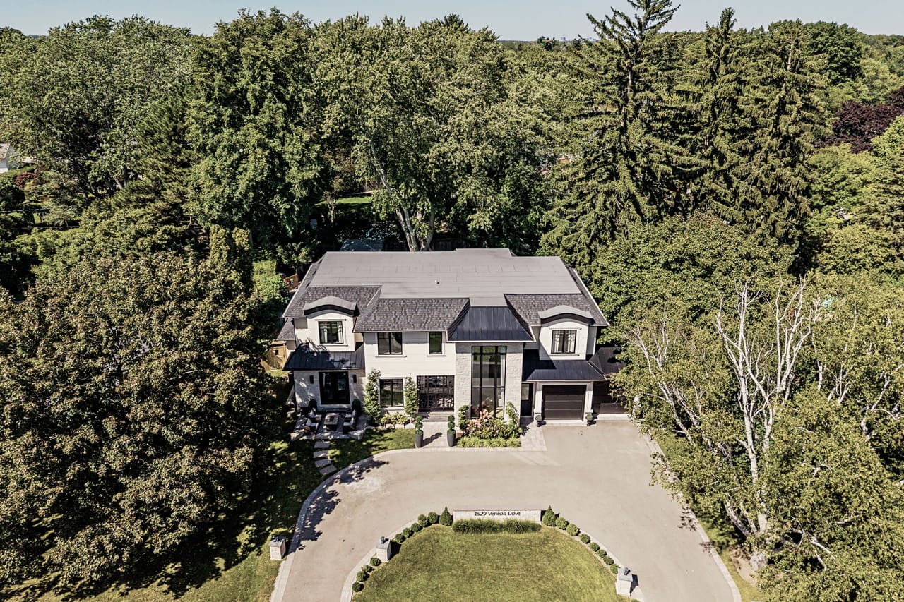 Aerial angle over the roof, the estate among the mature canopy of Southwest Oakville