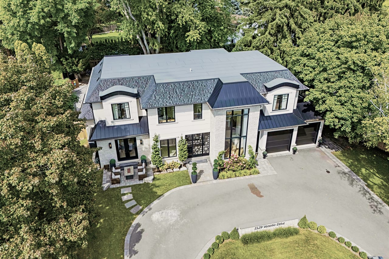 Aerial approach to the front of the house, driveway and entry court below