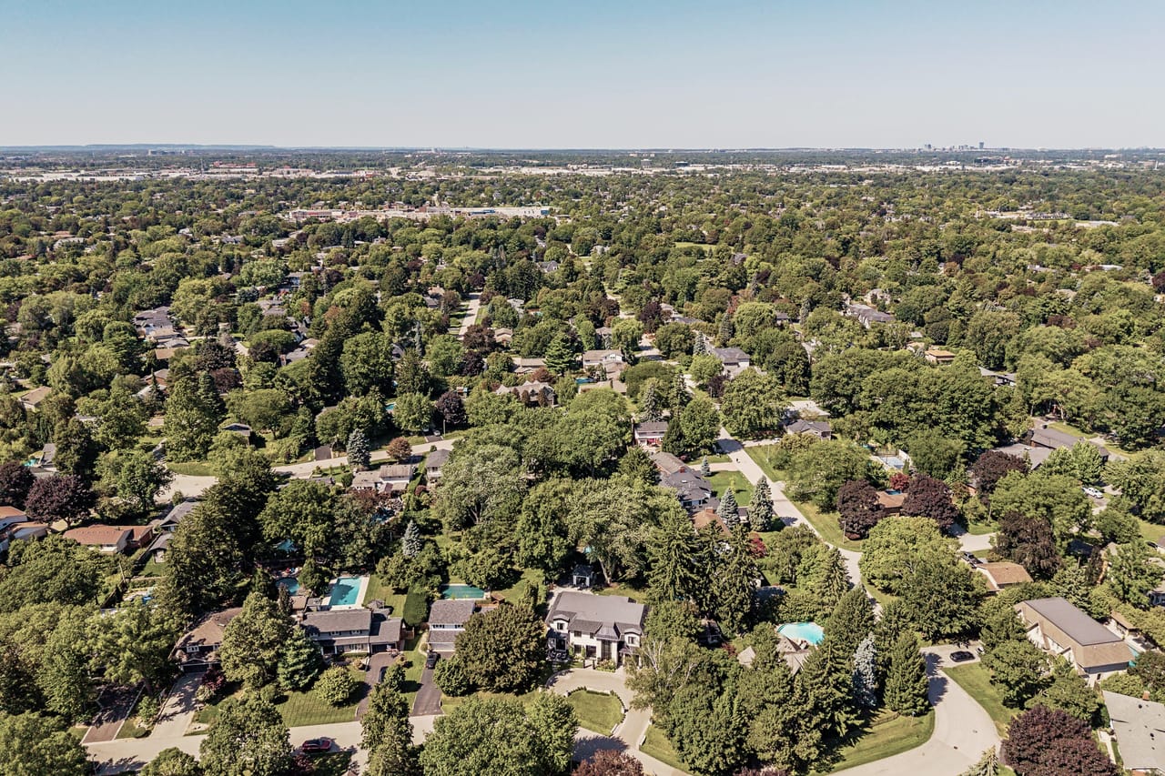 The wider Oakville shoreline from altitude, Toronto faint on the eastern horizon