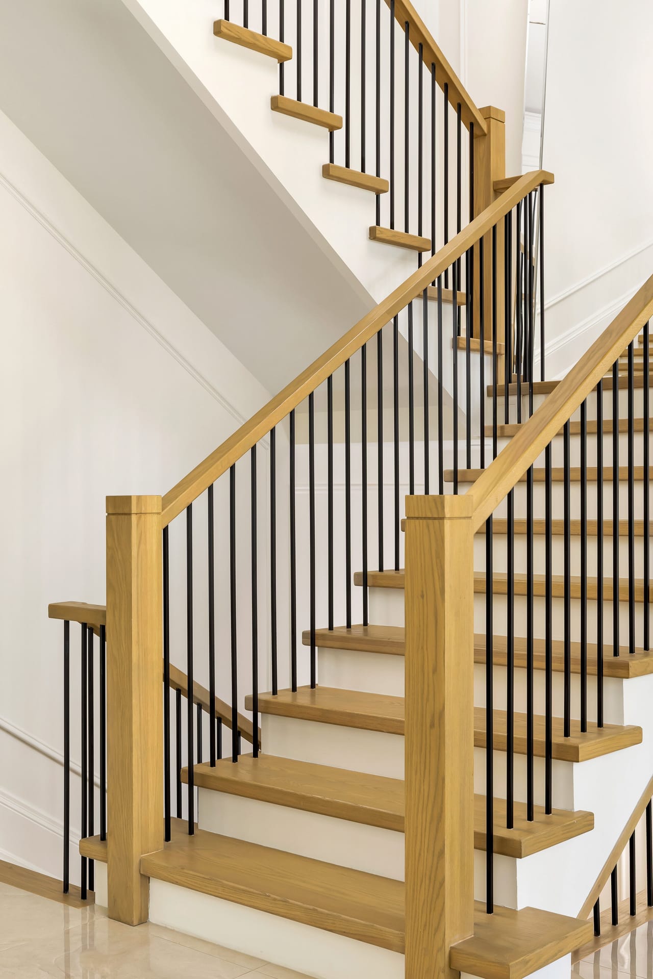 Detail of the floating oak treads and iron spindle railing