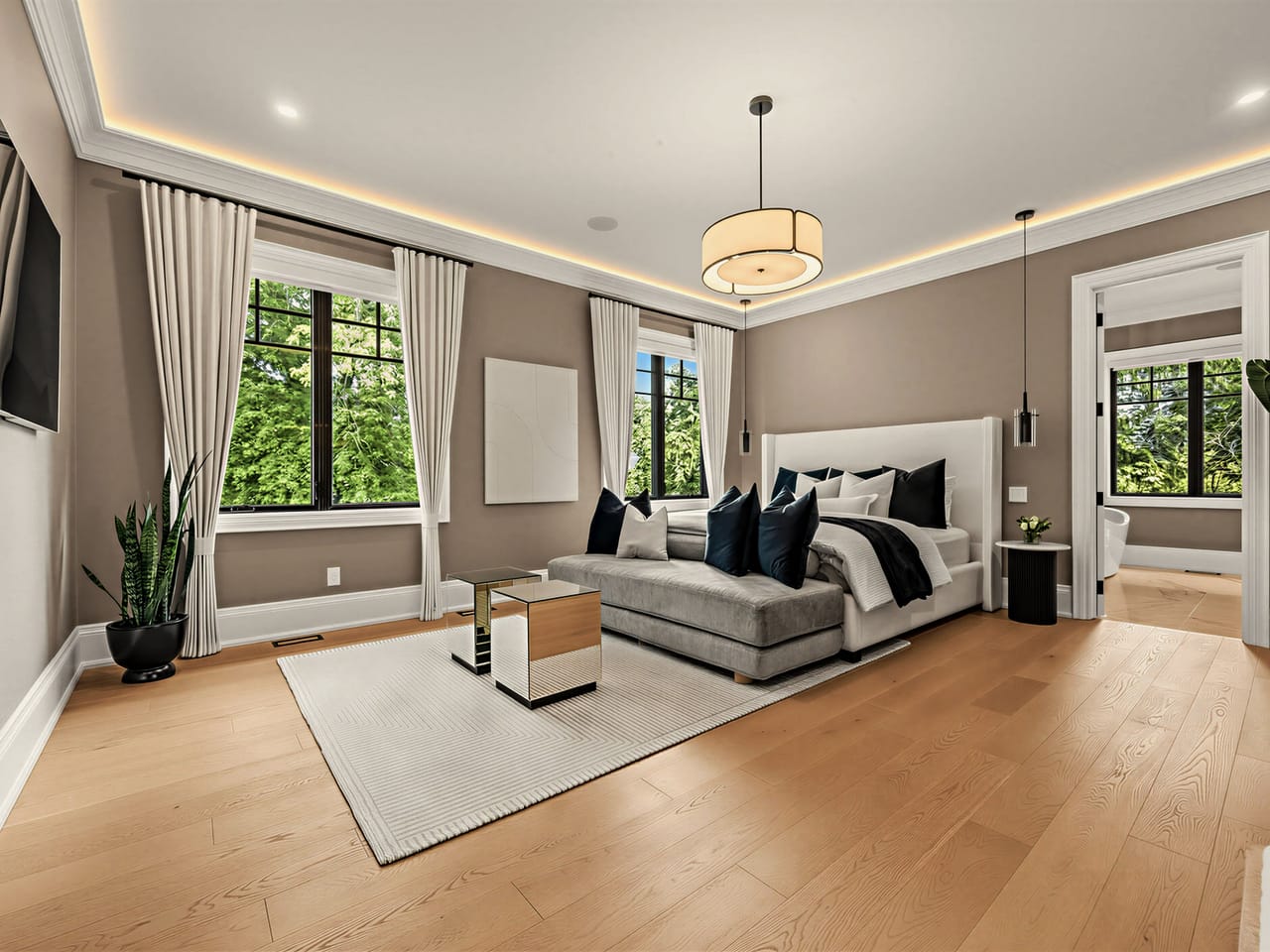 The primary bedroom, the bed set between two walls of garden window